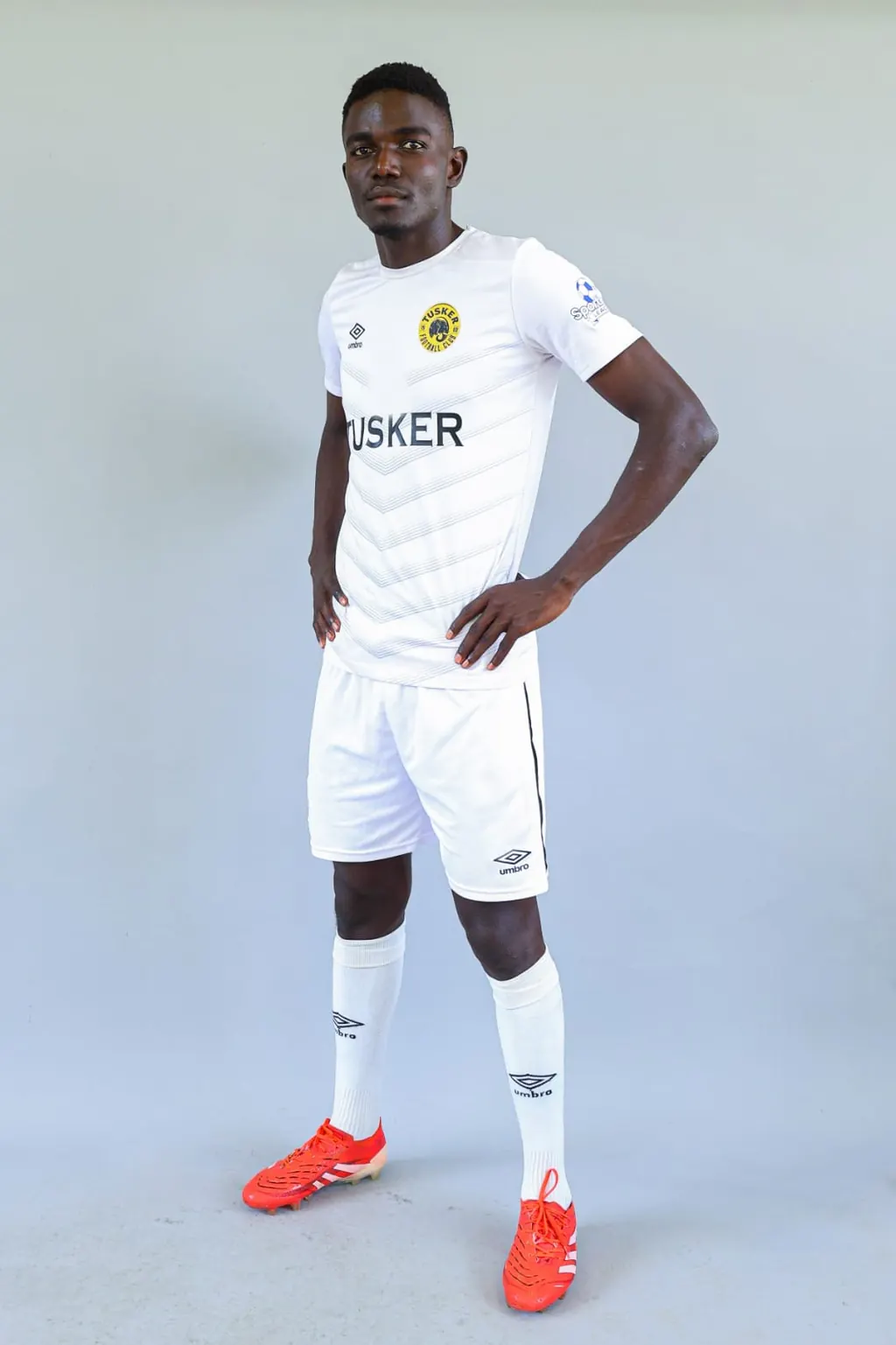 Stephen Ochieng Omondi in a white Tusker Football Club kit, photographed against a plain backdrop.