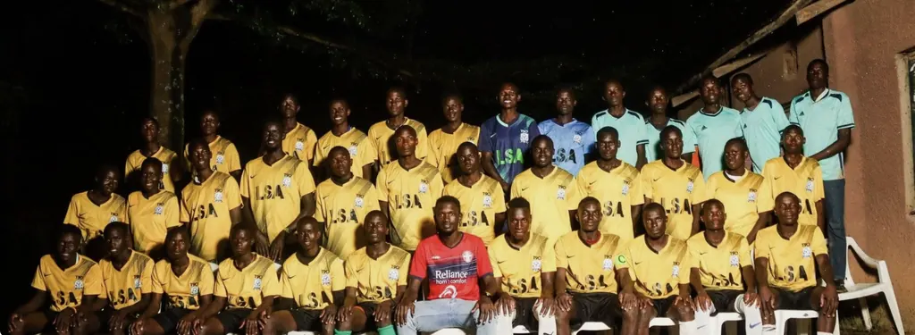 The Ligega Sports squad, in the club's yellow home kit, photographed together in rows.